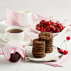 Breakfast. Tea with chocolate chip cookies on a white tray.