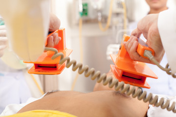Defibrillating a patient, the treatment for immediately life-threatening arrhythmias with which the patient does not have a pulse - obrazy, fototapety, plakaty