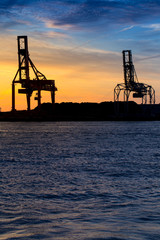 Fototapeta na wymiar Industrial port, nice Sunset sky with silhouette industrial port, Osaka, Japan