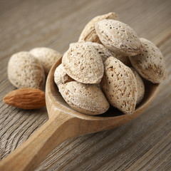 Almonds in wooden spoon