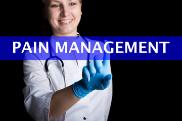 Internet and technology concept. smiling female doctor presses a finger on a virtual screen. pain management written on a virtual panel. Internet technologies in medicine