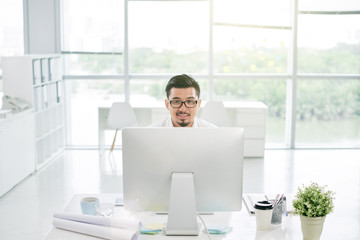 Portrait of Asian businessman working computer at his table