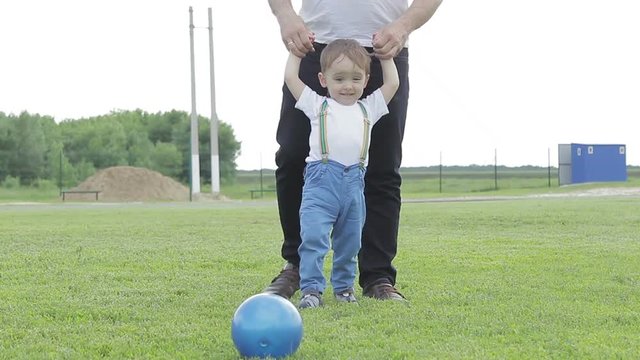 Little boy and dad walking holding hands