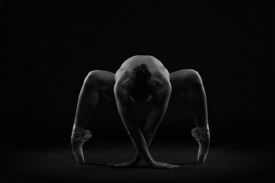 Fototapeta Art nude. Perfect flexible sexy body of young woman on black background