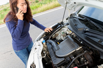 Fototapeta na wymiar a woman call emergency car service after her car has a ploblem