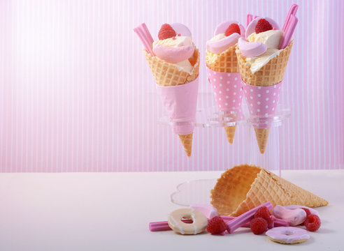 Pink candy ice creams in cones.