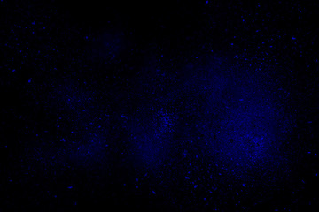Fototapeta na wymiar Blue abstract powder explosion on a black background