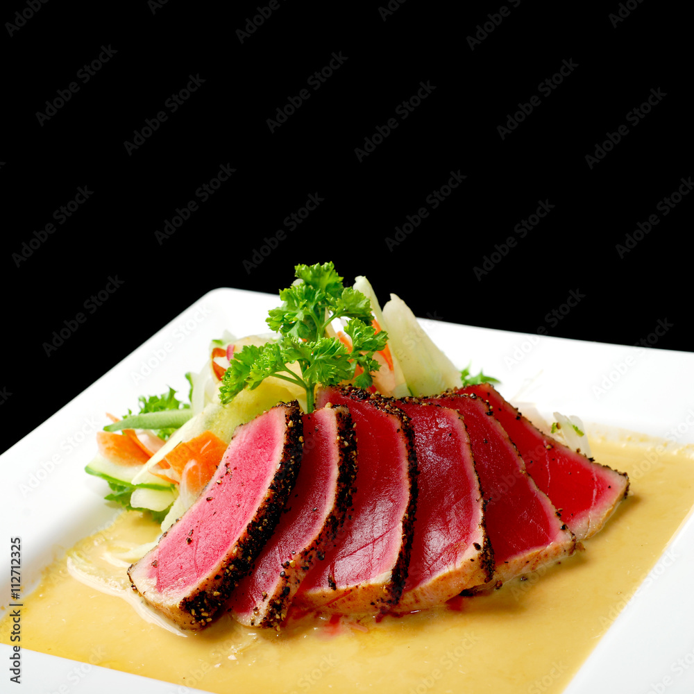 Wall mural Premium raw japanese kobe beef sliced on plate with black pepper