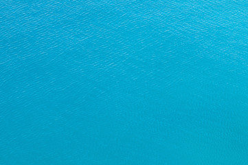 Water surface background. Calm, slightly rippled water surface shot from above