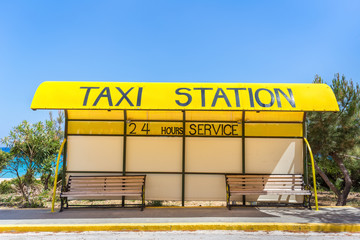 Yellow taxi station at coast in Greece