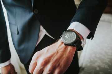 Groom wearing a new watch in the wrist.