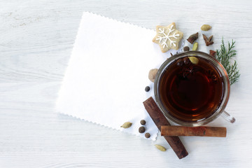 Christmas fragrant tea/ festive background with black tea decorated with fragrant spices and ginger cookies in the form of a Christmas Star top view 