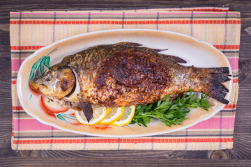 Fried fish carp on the plate