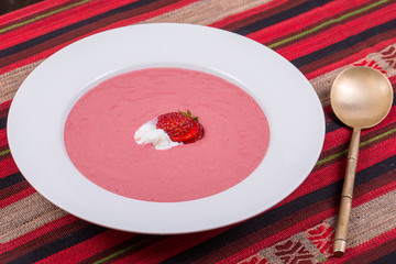Strawberry soup with fruit and ice cream