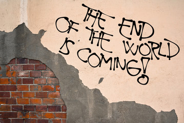 The End Of THe World Is Coming - Handwritten graffiti sprayed on the wall, anarchist aesthetics. Warning on ecological catastrophe, explosion of nuclear weapon, crash with asteroid, pandemics