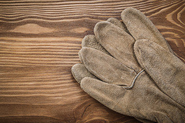Brown protective gloves on vintage wood board construction conce