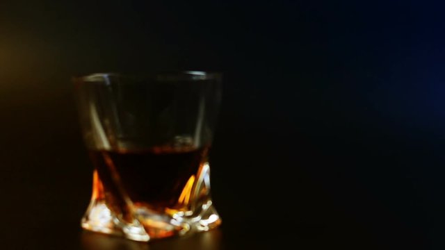 Man's drinking whiskey on black background
