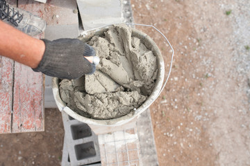 ready to use cement and old shovels at a construction site bucket