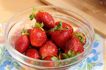 Fresh strawberry in a transparent salad bowl