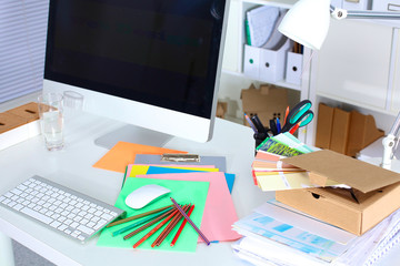 Designer working place with computer and paperwork