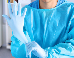 Surgeon putting on gloves before a close-up operation