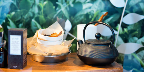 Tea Set with teapot, green tea, floral background