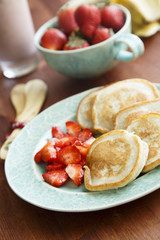 Vegan pancakes with banana and strawberry salad