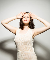 Fototapeta premium close-up portret of beautiful young brunette woman in a transparent dress posing and expresses different emotions