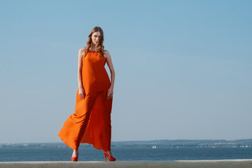 pretty girl on a pier in dress