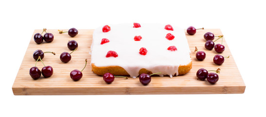 Square cake with cherry on