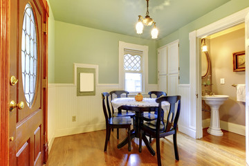 Small and cozy dining room with black wood table chair set and g