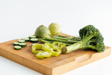 Fresh green vegetables on wooden board