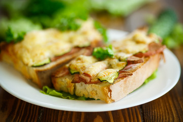 toast baked with sausage, cheese and cucumber