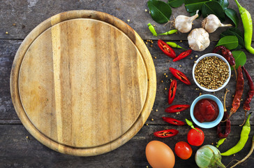 Obraz na płótnie Canvas cooking concept, fresh kitchen herbs and spices on wooden table. top view and nature light [over light]