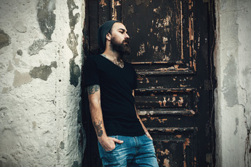 Portrait of brutal bearded man wearing blank t-shirt