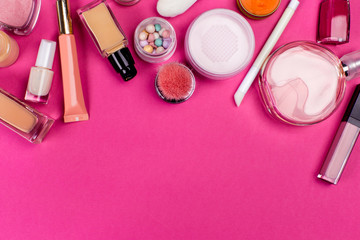 Obraz na płótnie Canvas Set of colorful cosmetics on pink table
