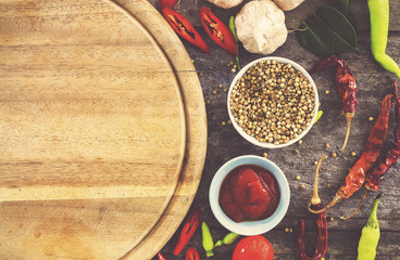 cooking concept, fresh kitchen herbs and spices on wooden table. top view and vintage tone [over light]