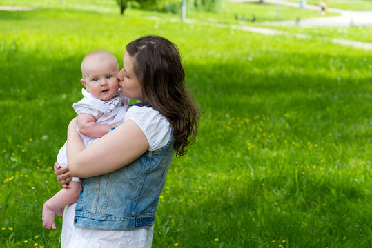 young woman and her cute baby girl outdoor