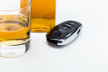 Car key on the bar with spilled alcohol