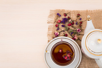Vintage cup of tea with buds of roses