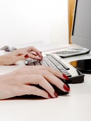 woman office worker typing on the keyboard