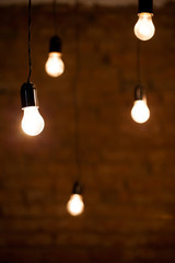 Light bulbs over brick all texture