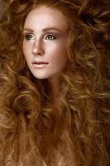 Beautiful Redhead girl with a perfectly creative curls hair and classic make-up. Beauty face.