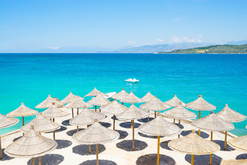 Sunshade umbrellas on the beautiful Ksamil beach, Albania. - obrazy, fototapety, plakaty