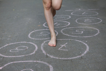hopscotch, Young girl playing hopscotch 
