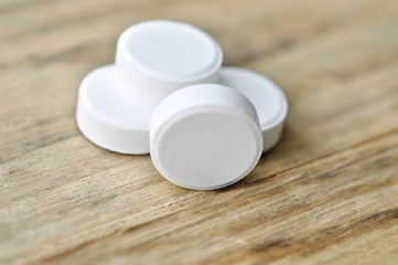 Big White Pills On Wood Table Background