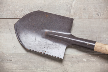 shovel with wooden handle on the table