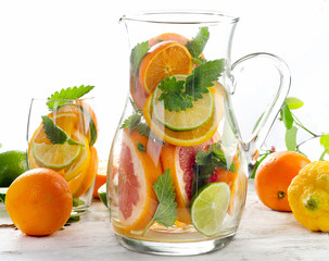Pitcher with citrus fruits and mint leaves.