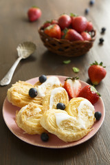 Puff pastry cookies with sugar glaze and berries
