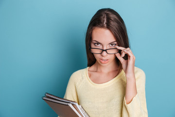 Portrait of smart pensive girl in glasses thinking about something